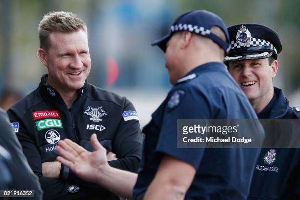 Magpies head coach Nathan Buckley reacts when talking to Victorian Police officers who attended training to watch their colleagues train with players...