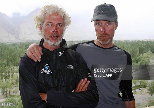 Dutch climber Las Van De Gevel and Wilco Van Rooijen pose at a hotel in Skardu on August 5 after their rescue from the slopes of K2 following an...