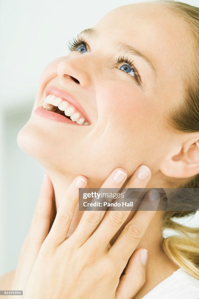 Woman laughing, looking up