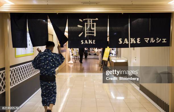 Customer arrives at a Sake Marche event in the Isetan Shinjuku department store, operated by Isetan Mitsukoshi Holdings Ltd., in Tokyo, Japan, on...