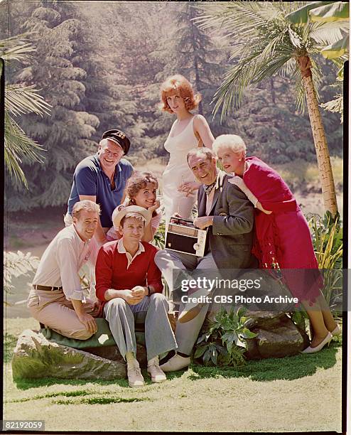 Promotional portrait shows the cast of 'Gilligan's Island' as they listen to a portable radio, early 1960s. Pictured are, from left, American actors...