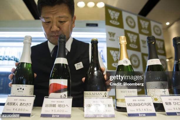 Member of the Japan Awasake Association displays bottles of sparkling sake including the Nanbu-Bijin Awasake Sparkling, brewed by Nanbu-Bijin Co.,...