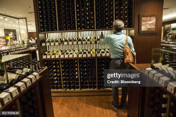 Customer browses European wines at the Isetan Shinjuku department store, operated by Isetan Mitsukoshi Holdings Ltd., in Tokyo, Japan, on Tuesday,...