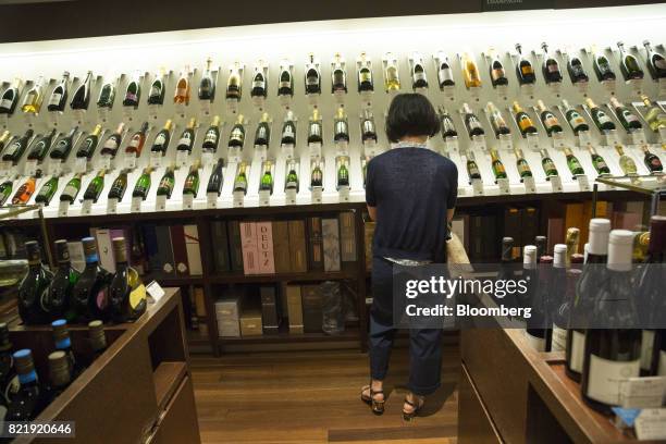 Customer browses European wines at the Isetan Shinjuku department store, operated by Isetan Mitsukoshi Holdings Ltd., in Tokyo, Japan, on Tuesday,...