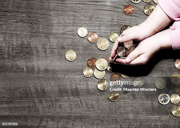 child's hands holding coins - kids money fotografías e imágenes de stock
