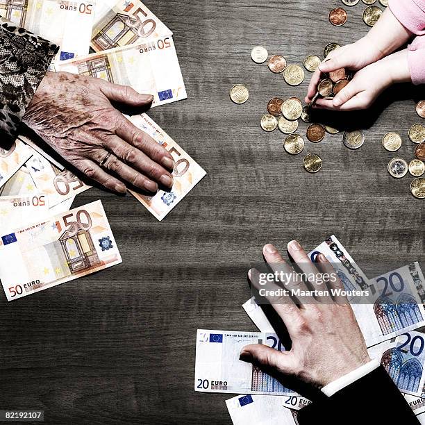 3 people's hands with money on table - euro in hand stock pictures, royalty-free photos & images