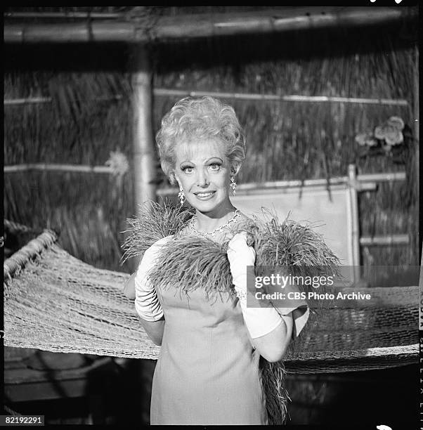 Portrait of American actress Natalie Schafer as she holds a feather boa at her neck in an episode of the television comedy 'Gilligan's Island'...