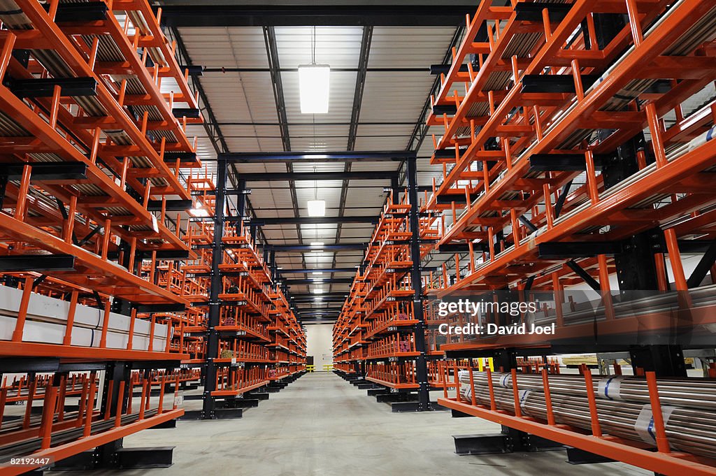 Long industrial metal bars on huge racks