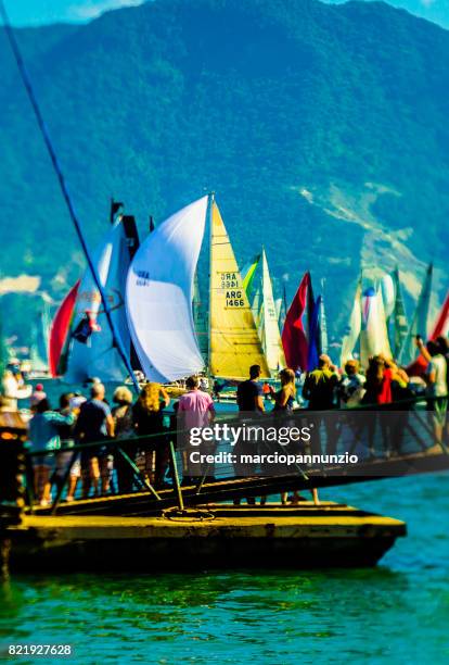 opening of ilhabela sailing week when the parade of sailboats happens in front of the píer da vila in ilhabela, brazil - píer stock pictures, royalty-free photos & images