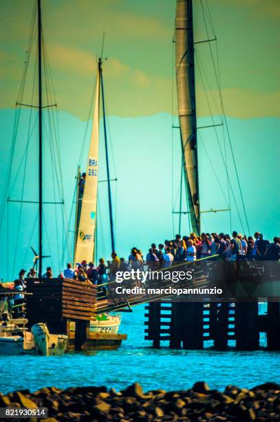 opening of ilhabela sailing week when the parade of sailboats happens in front of the píer da vila in ilhabela, brazil - píer stock pictures, royalty-free photos & images