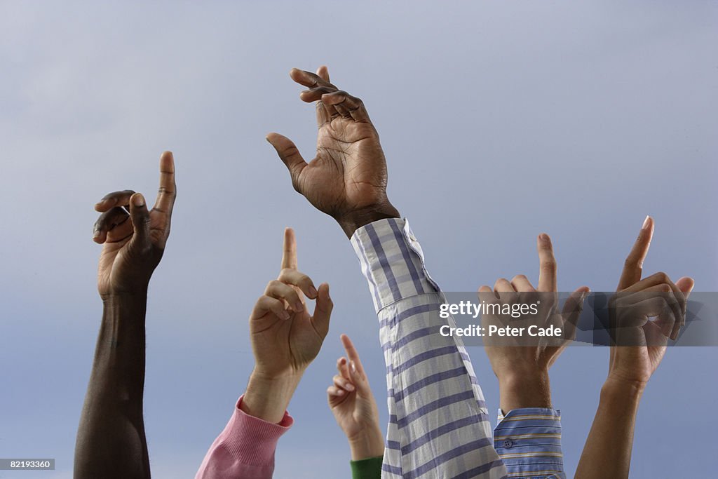 Six peoples arms in the air