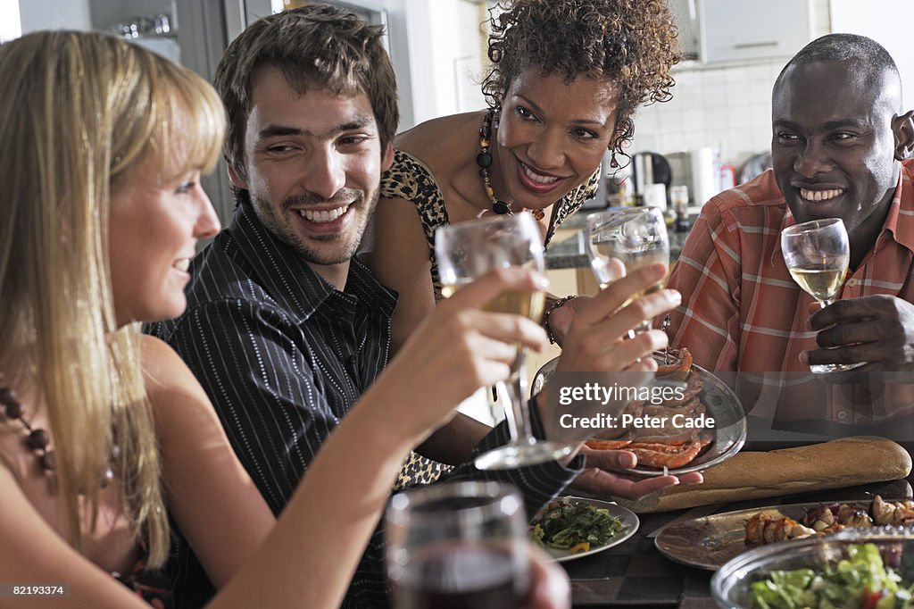 Adults having a dinner party