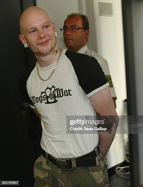 Police lead Tom W. Away from the courtroom after he was convicted of causing causing bodily harm at the conclusion of his trial on August 6, 2008 in...