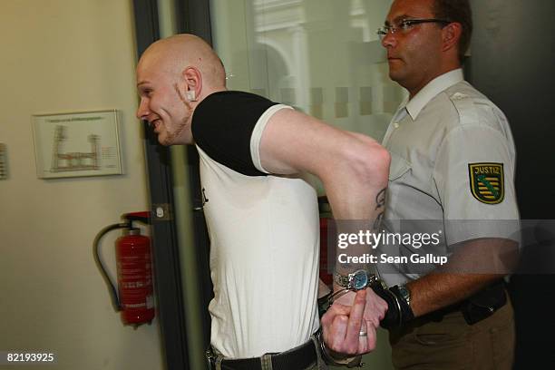 Police lead Tom W. Away from the courtroom after he was convicted of causing causing bodily harm at the conclusion of his trial on August 6, 2008 in...