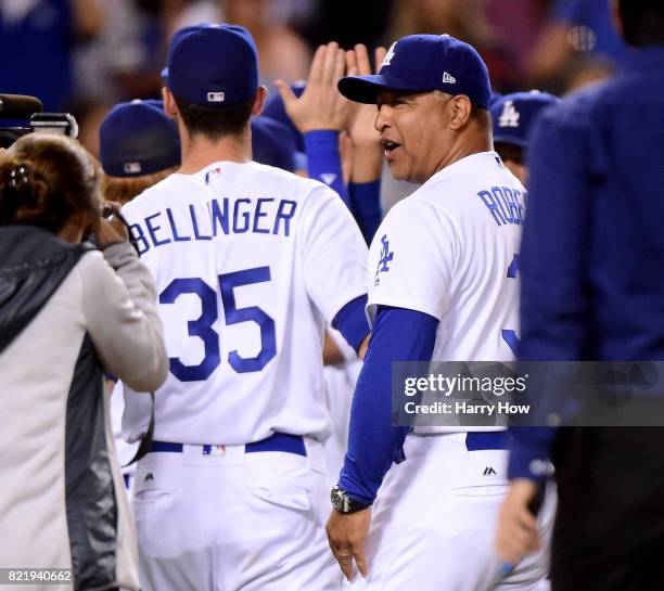 Manager Dave Roberts of the Los Angeles Dodgers celebrates a 6-4 win over the Minnesota Twins with Cody Bellinger at Dodger Stadium on July 24, 2017...