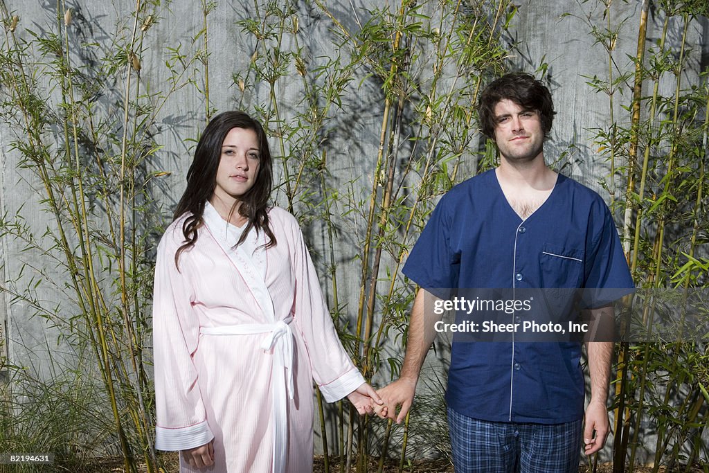 Young couple  in front of  ofbamboo