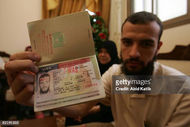 Palestinian scholar Fidaa Abed displays his Palestinian passport, with cancelled stamp on the visa from the United States as he sits in his family...
