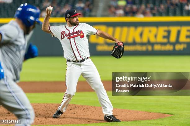 Josh Collmenter of the Atlanta Braves throws to first base against the Toronto Blue Jays at SunTrust Park on May 18, 2017 in Atlanta, Georgia. The...