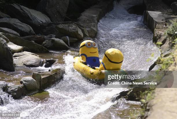 Tourists dressed as Minions drift in a river at Lianyuan on July 24, 2017 in Loudi, Hunan Province of China. Tourists in the Minions costumes enjoyed...