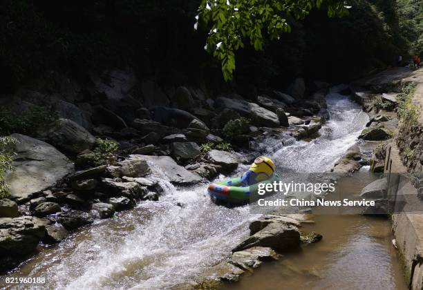 Tourist dressed as Minions drifts in a river at Lianyuan on July 24, 2017 in Loudi, Hunan Province of China. Tourists in the Minions costumes enjoyed...