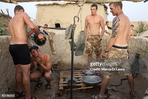 British Army soldiers from the 3rd Battalion The Parachute Regiment wash themselves during operation Southern Beast on August 6, 2008 in Maywand...