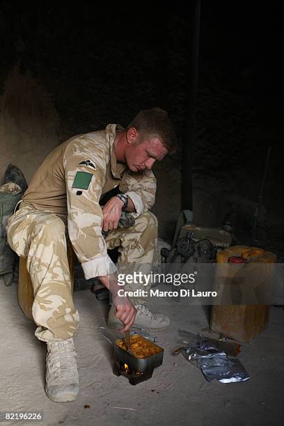 British Army soldier from the 3rd Battalion The Parachute Regiment cooks his 'ready to eat' individual meal ration during operation Southern Beast on...
