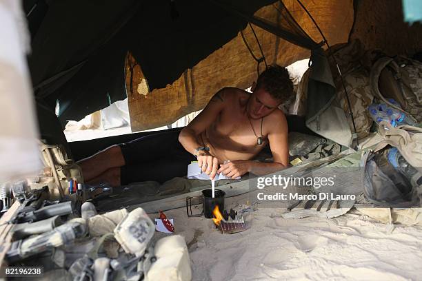 British Army soldier from the 3rd Battalion The Parachute Regiment cooks his 'ready to eat' individual meal ration during operation Southern Beast on...