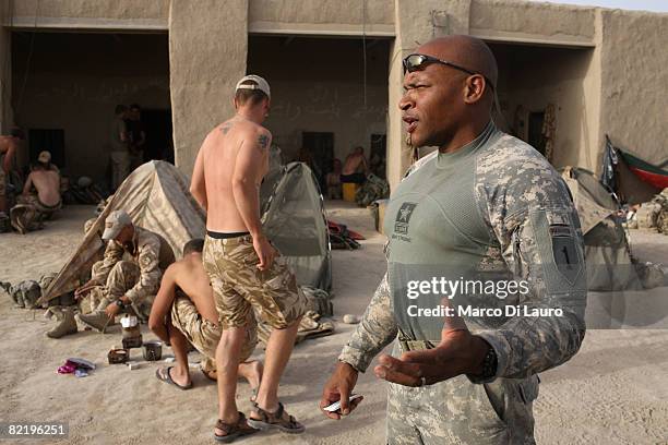 Army Major Steve Ruth from Texas attached to British Army soldiers from the 3rd Battalion The Parachute Regiment gestures as he talks to other U.S....