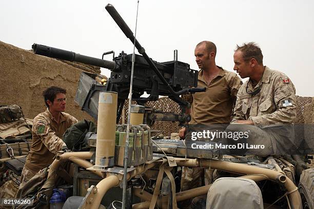 Canadian Army Brigadier General Denis Thompson, Commander of the ISAF Task Force Kandahar talk to two British Army soldiers from the 3rd Battalion...