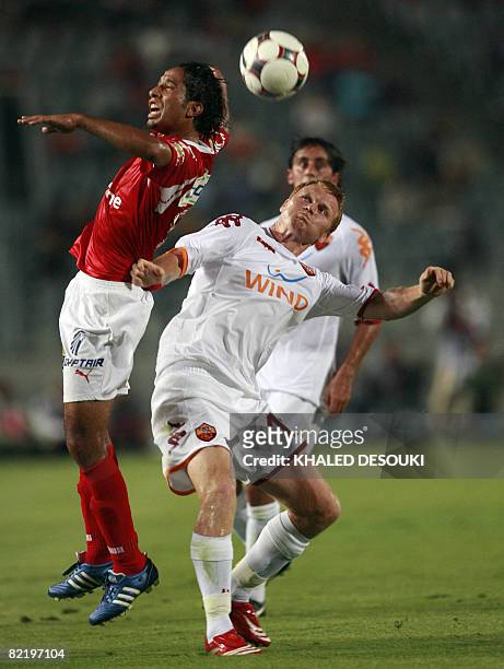 Roma's player John Arne Riise vies with Egyptian player Ahmed Hassan of Al-Ahly club during their friendly football match in Cairo on August 6, 2008....