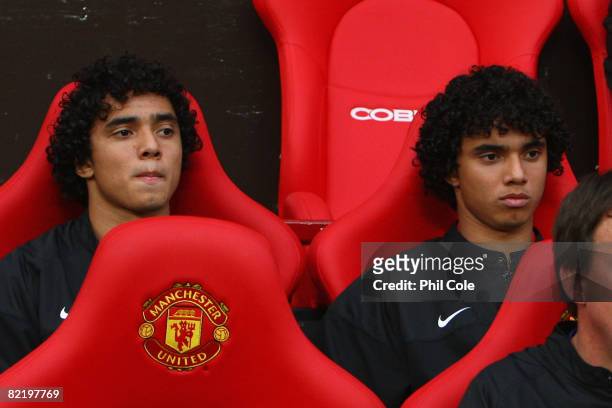 Rafael Da Silva sits on the bench beside his twin brother and team mate Fabio Da Silva of Manchester United prior to the Pre Season Friendly match...