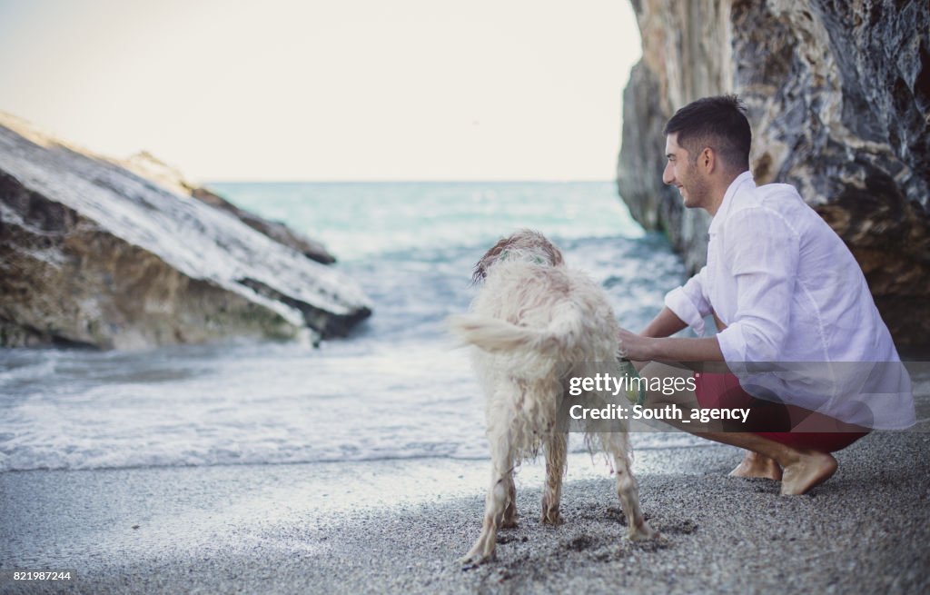 Man playing with his best friend on the beach