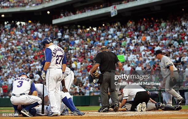 David Murphy of the Texas Rangers lies on the ground after a collision at homeplate with catcher Ivan Rodriguez of the New York Yankees on August 6,...