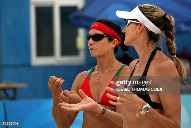 World and olympic champion Kerri Walsh chats with teammate Misty May-Treanor during a practice session at Beijing's Chaoyang Park Beach volleyball...