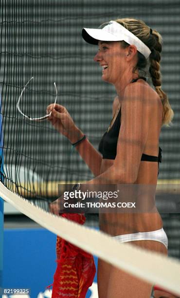 World and olympic champion Kerri Walsh is pictured through the net during a practice session at Beijing's Chaoyang Park Beach volleyball ground on...