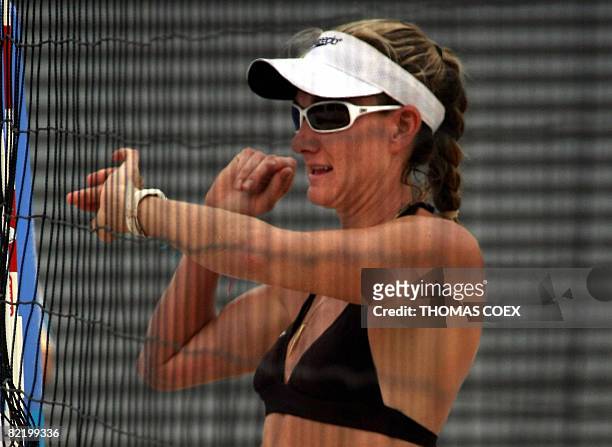 World and olympic champion Kerri Walsh looks at her watch during a practice session at Beijing's Chaoyang Park Beach volleyball ground on August 7 on...