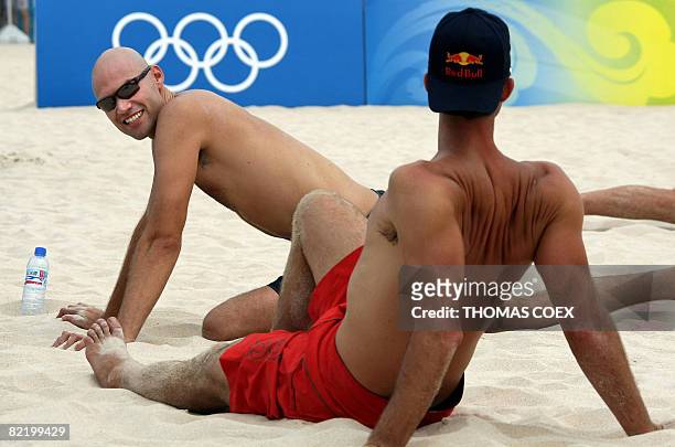 World and olympic champion Phil Dalhausser and teammate Todd Rogers warm up during a practice session at Beijing's Chaoyang Park Beach volleyball...