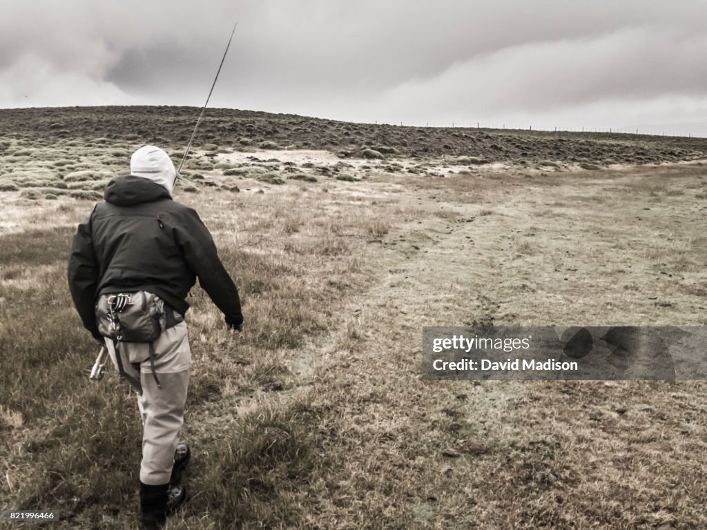 Fisherman walking to river