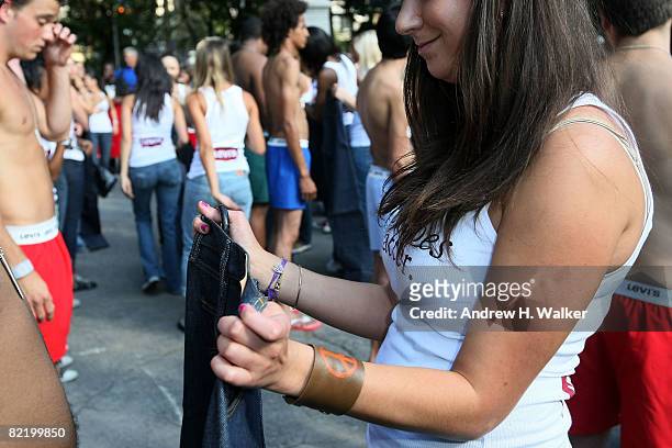 Women search for men who will fit into their jeans at the Levi's "Size Does Matter" game on August 6, 2008 in New York City.