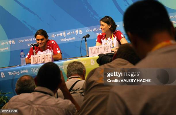 Swiss tennis player Roger Federer and press officer of the Swiss Olympic team Claudia Imhasly give a press conference ahead of the 2008 Beijing...