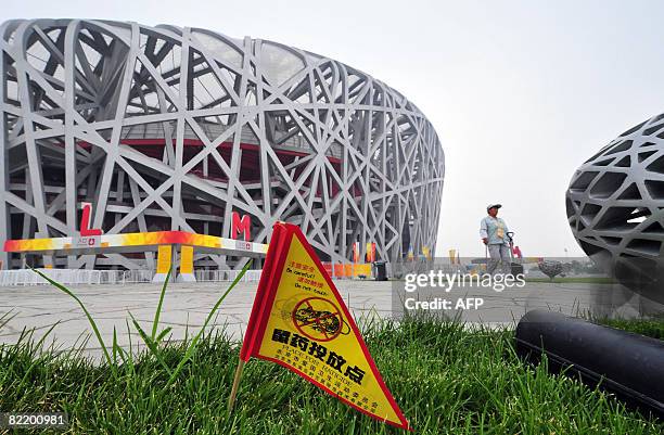 Flag informing of rat poison on the grass is pictured on August 7, 2008 in Beijing next to the National Stadium, also known as the "Bird's Nest",...