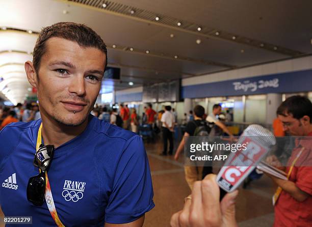 French triathlete Frederic Belaubre arrives at the International Beijing Airport on August 7, 2008 on the eve of the opening ceremony of the 2008...