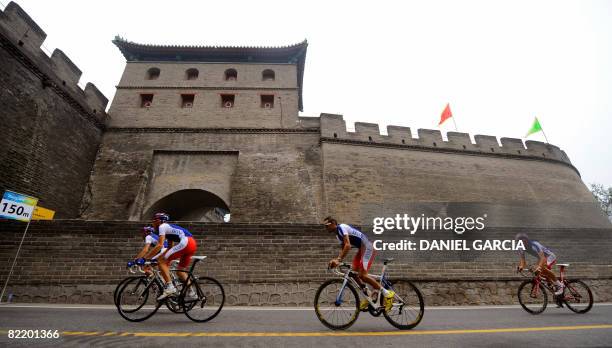 Members of the road cycling teams from France take part in an official training session near the Great Wall of China in Badaling, 78 km north of...