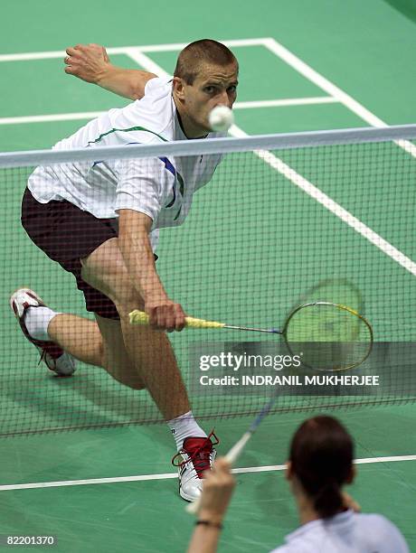 Denmark's Jens Jeriksen plays a shot to compatriot Kamilla Juhl during a training session in Beijing, on August 07, 2008 on the eve of the opening...