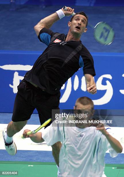 Denmark's Martin Hansen prepares to play a shot in front of team-mate Jens Eriksen during a training session in Beijing, on August 07, 2008 on the...