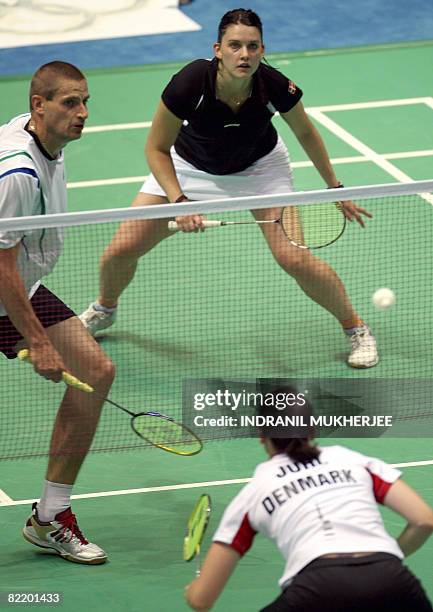 Denmark's Jens Jeriksen plays a shot in front ot team-mates Lena Frier Kristiansen and Kamilla Juhl during a training session in Beijing, on August...