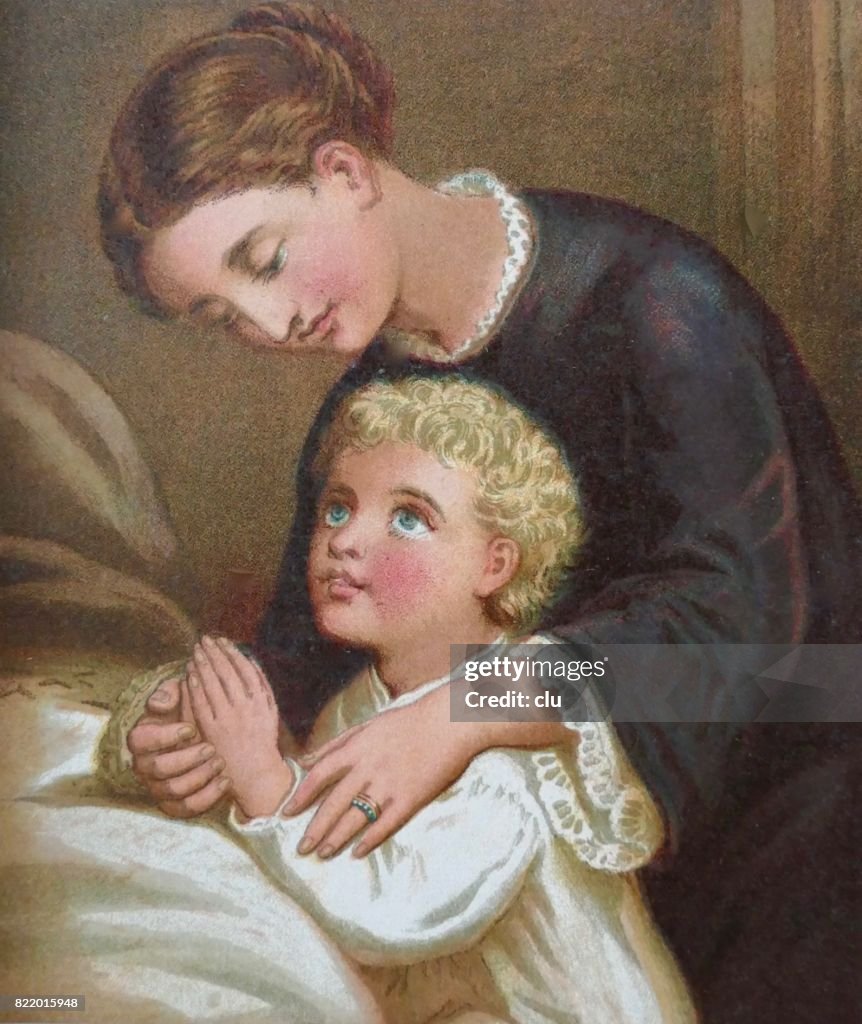 Mother and son praying at bed