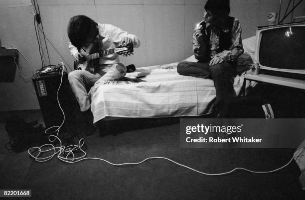 George Harrison and Ringo Starr in their dressing room before a Beatles concert at the Rizal Memorial Football Stadium, Manila, Philippines, during...