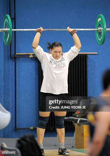 China's weightlifter Cao Lei practices in a training hall of the Beijing University of Aeronautics and Astronautics Gymnasium in Beijing on August 7,...