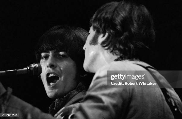 George Harrison and John Lennon performing with the Beatles at the Rizal Memorial Football Stadium, Manila, Philippines, during the group's final...